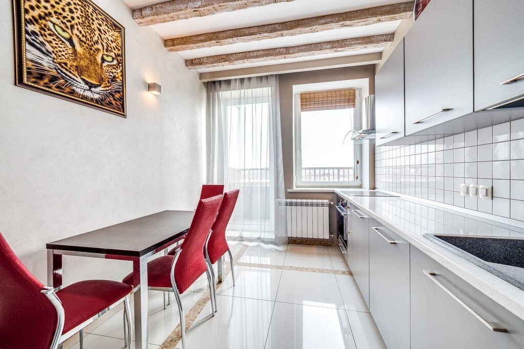 A narrow kitchen with a balcony