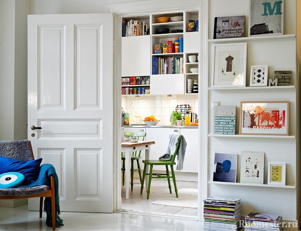 A narrow shelving unit behind the door