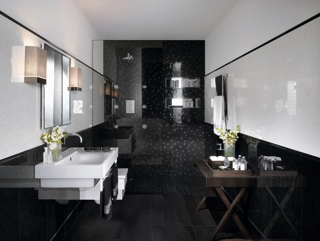 A bathtub with black tiles