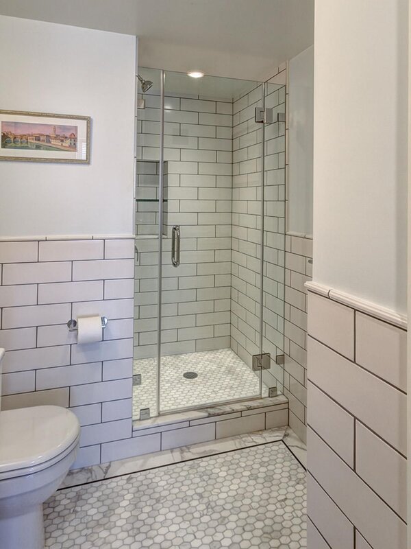 Bathtub with a tiled shower cabin