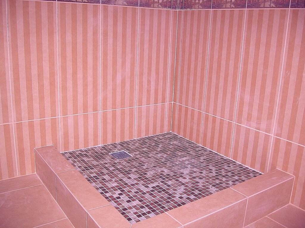 A bathtub with a tile base