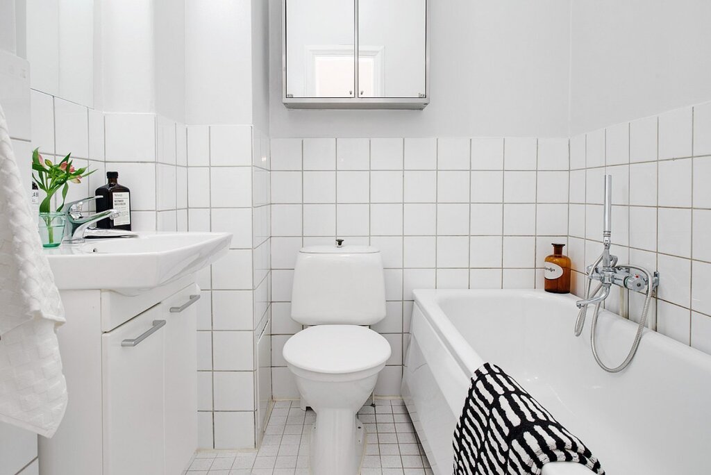 Bathroom and toilet in white tiles