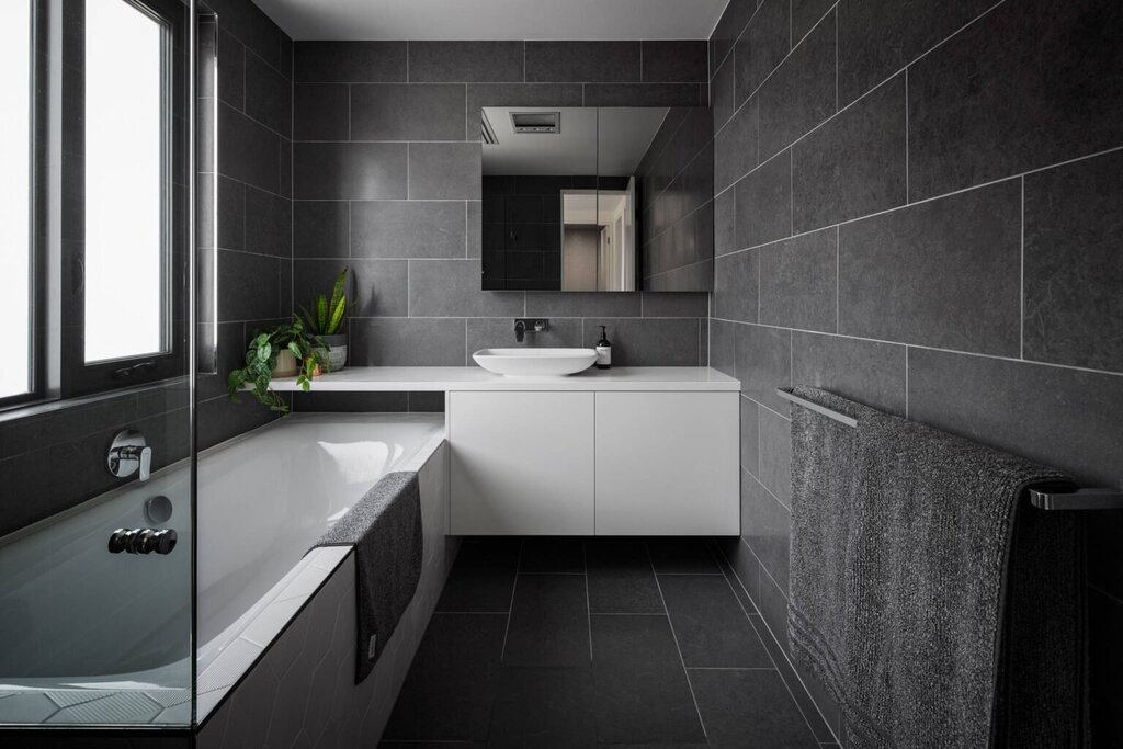 Bathroom with black tiles