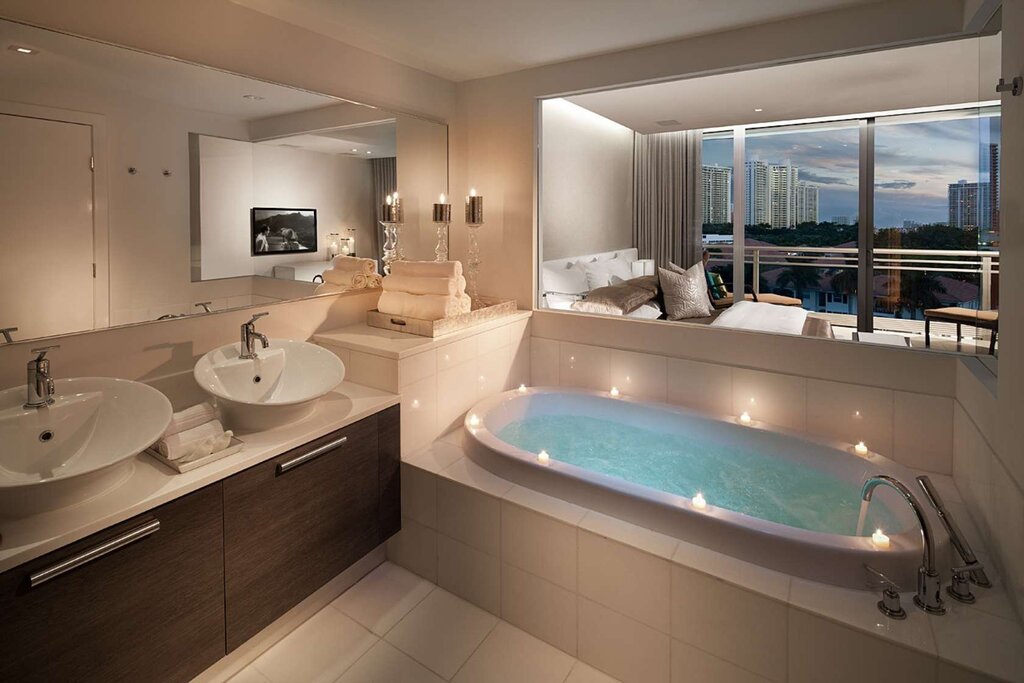 Bathroom with a jacuzzi and a toilet