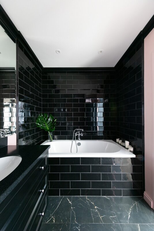 Bathroom with dark tiles