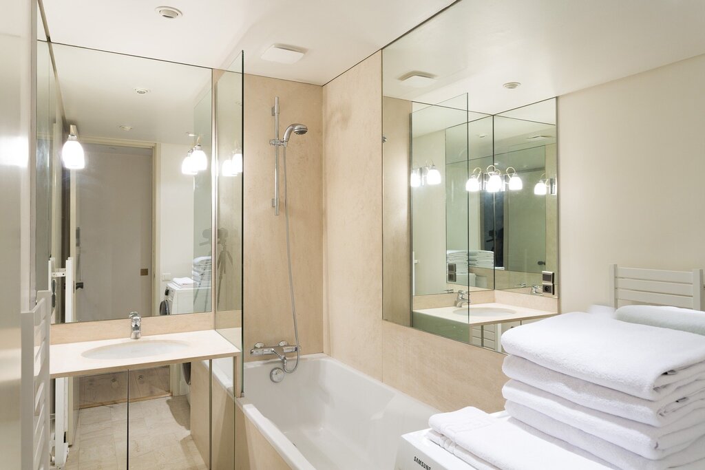 A bathroom with a large mirror