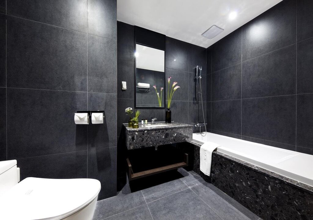 Bathroom with black tiles