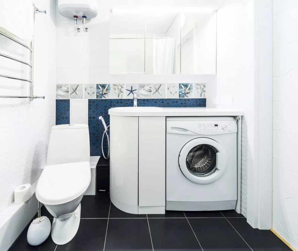 Bathroom with a toilet and washing machine