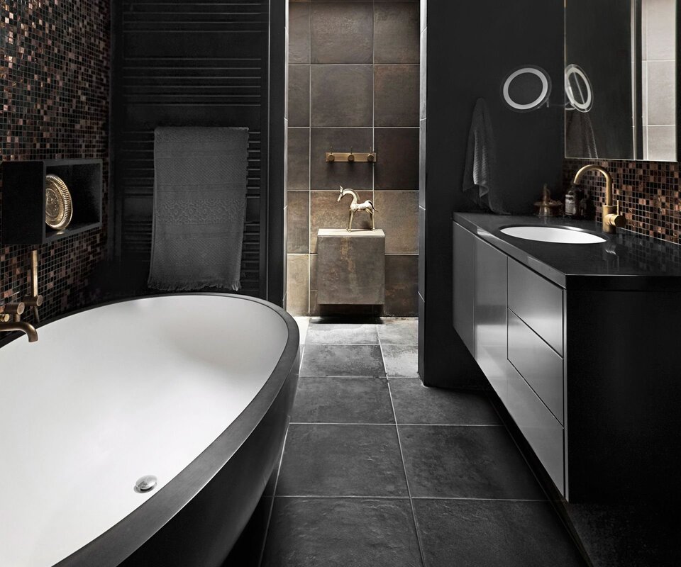 A bathroom in dark tones