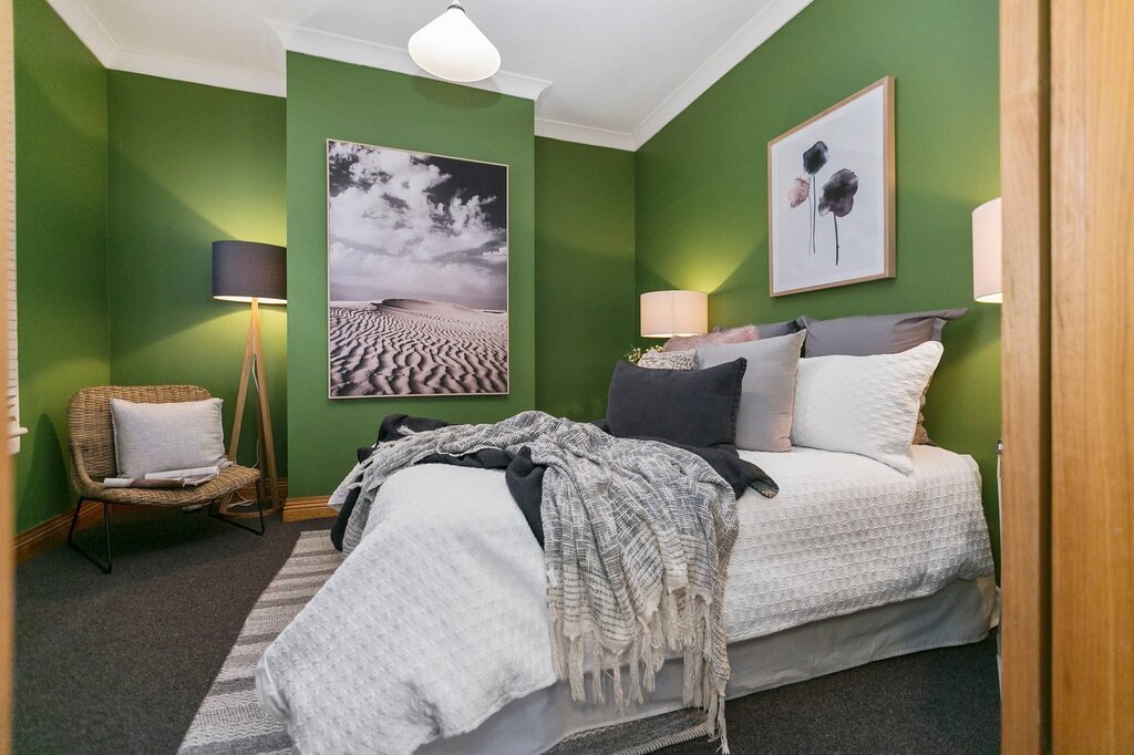 Green walls in the bedroom interior