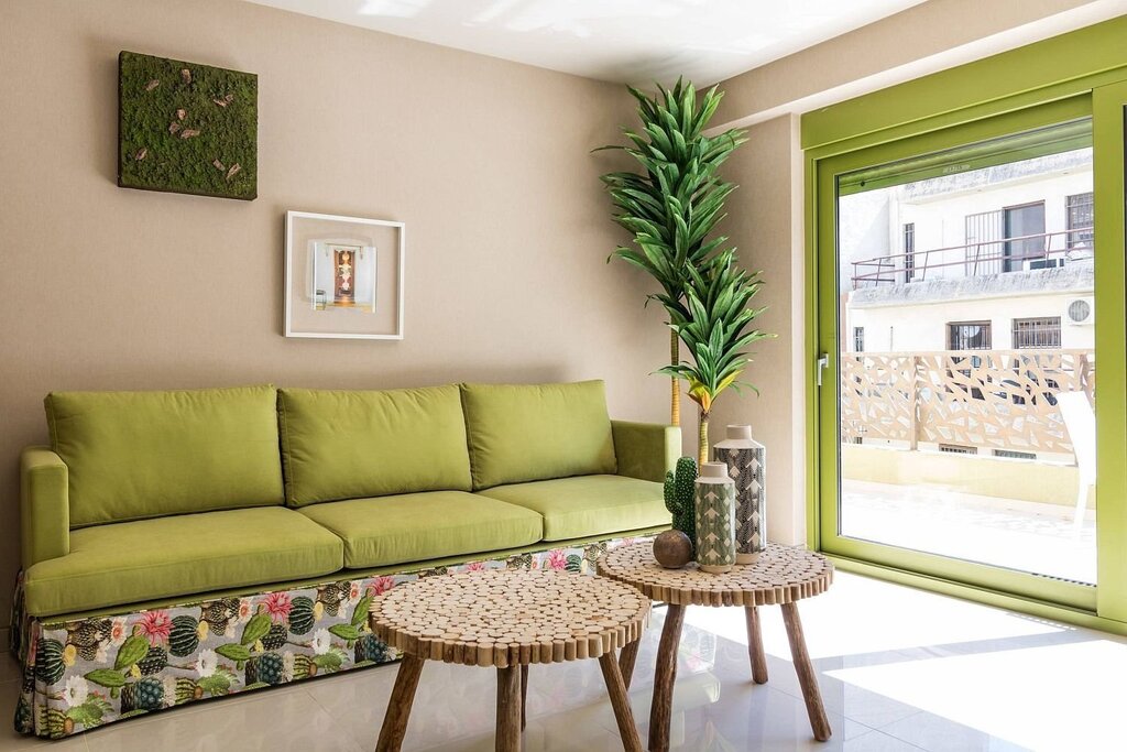 Green sofa in a beige interior