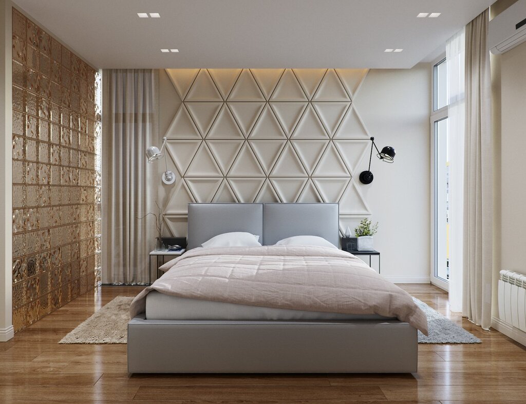 A mirrored wall in the bedroom behind the bed