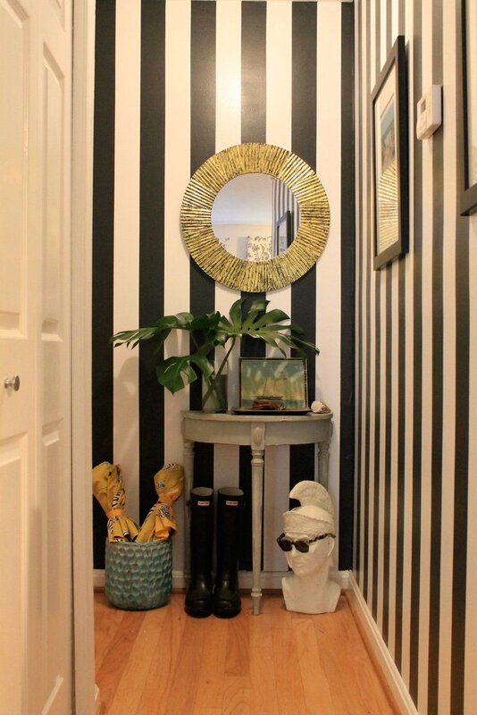 A mirror with stripes on the wall