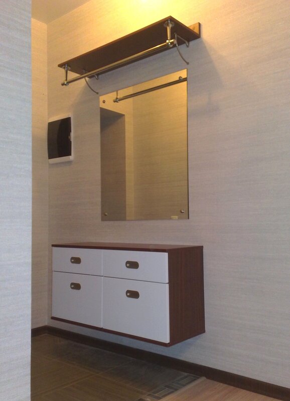 A mirror with a hanging cabinet for the hallway