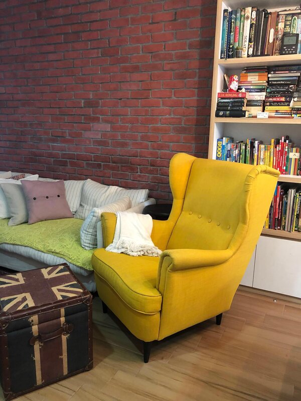 Yellow IKEA Strandmon armchair